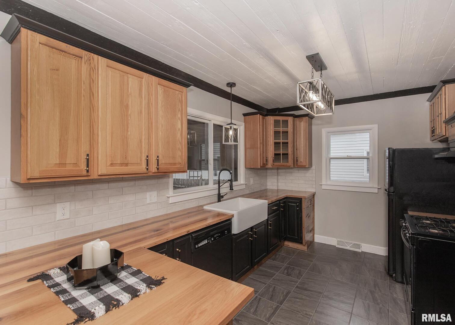 213 North Williams Street Geneseo, IL 61254 - Photo 16 of 42 a kitchen with stainless steel appliances granite countertop a sink stove and refrigerator