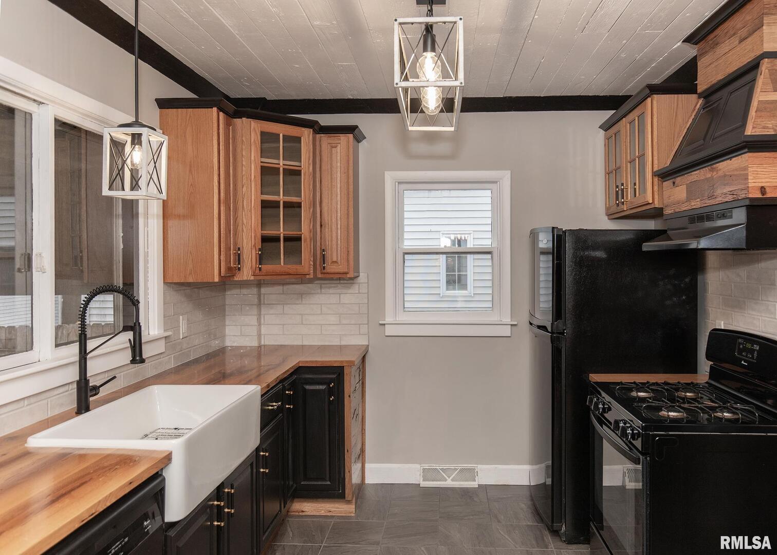 213 North Williams Street Geneseo, IL 61254 - Photo 17 of 42 a kitchen with a sink appliances and cabinets