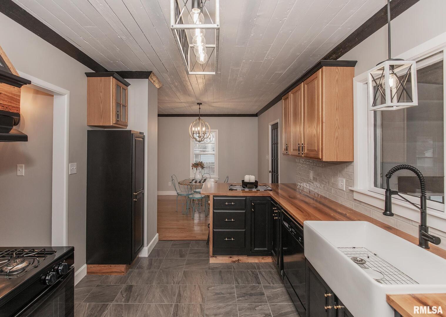 213 North Williams Street Geneseo, IL 61254 - Photo 19 of 42 a kitchen with stainless steel appliances granite countertop a refrigerator and a sink