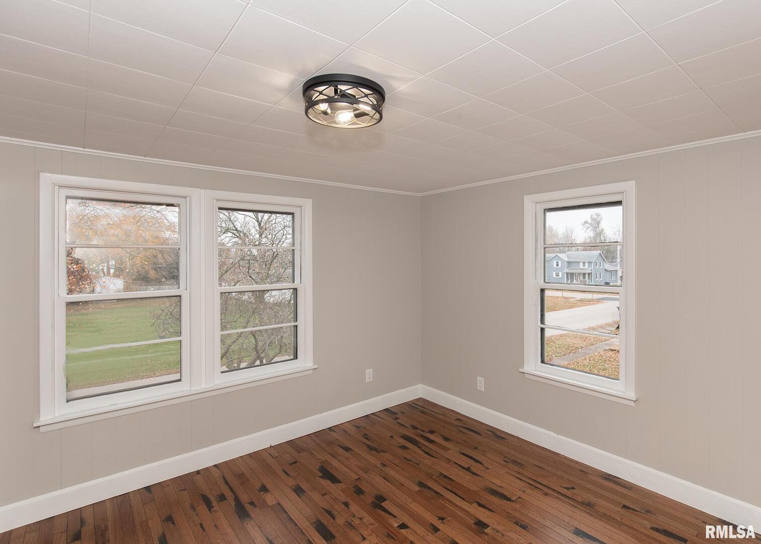 213 North Williams Street Geneseo, IL 61254 - Photo 24 of 42 a view of an empty room with wooden floor and a window