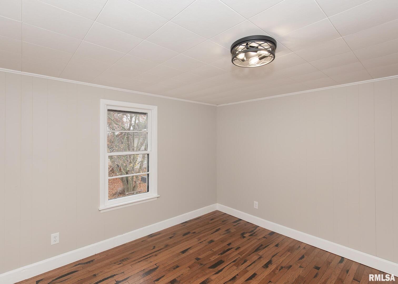 213 North Williams Street Geneseo, IL 61254 - Photo 27 of 42 a view of an empty room with window and wooden floor