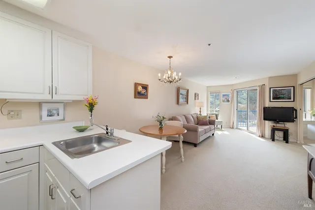 a view of living room kitchen with furniture and wooden floor