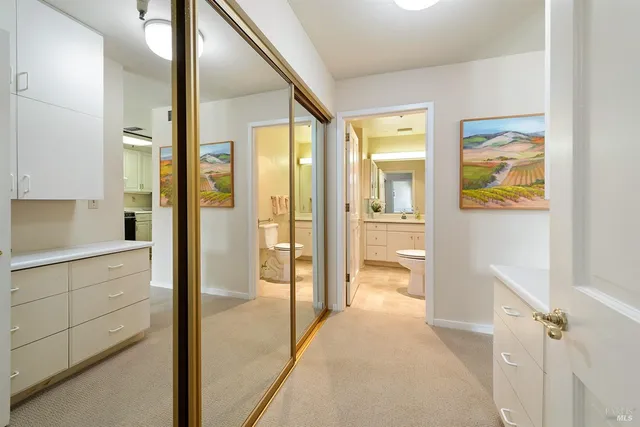 a bathroom with a granite countertop toilet sink and mirror