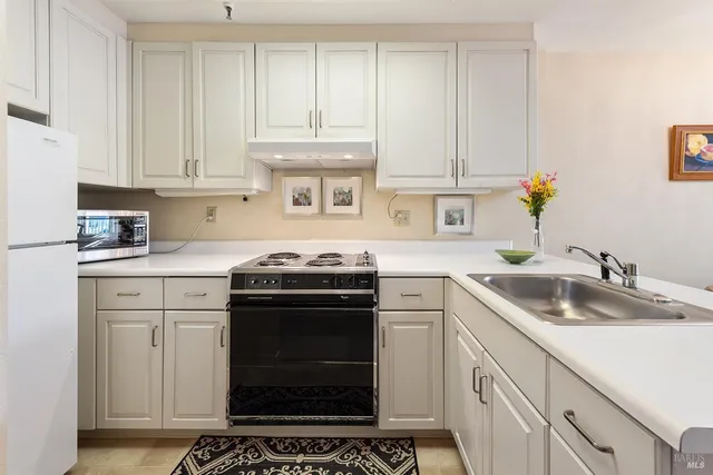 a kitchen with a sink stove and cabinets