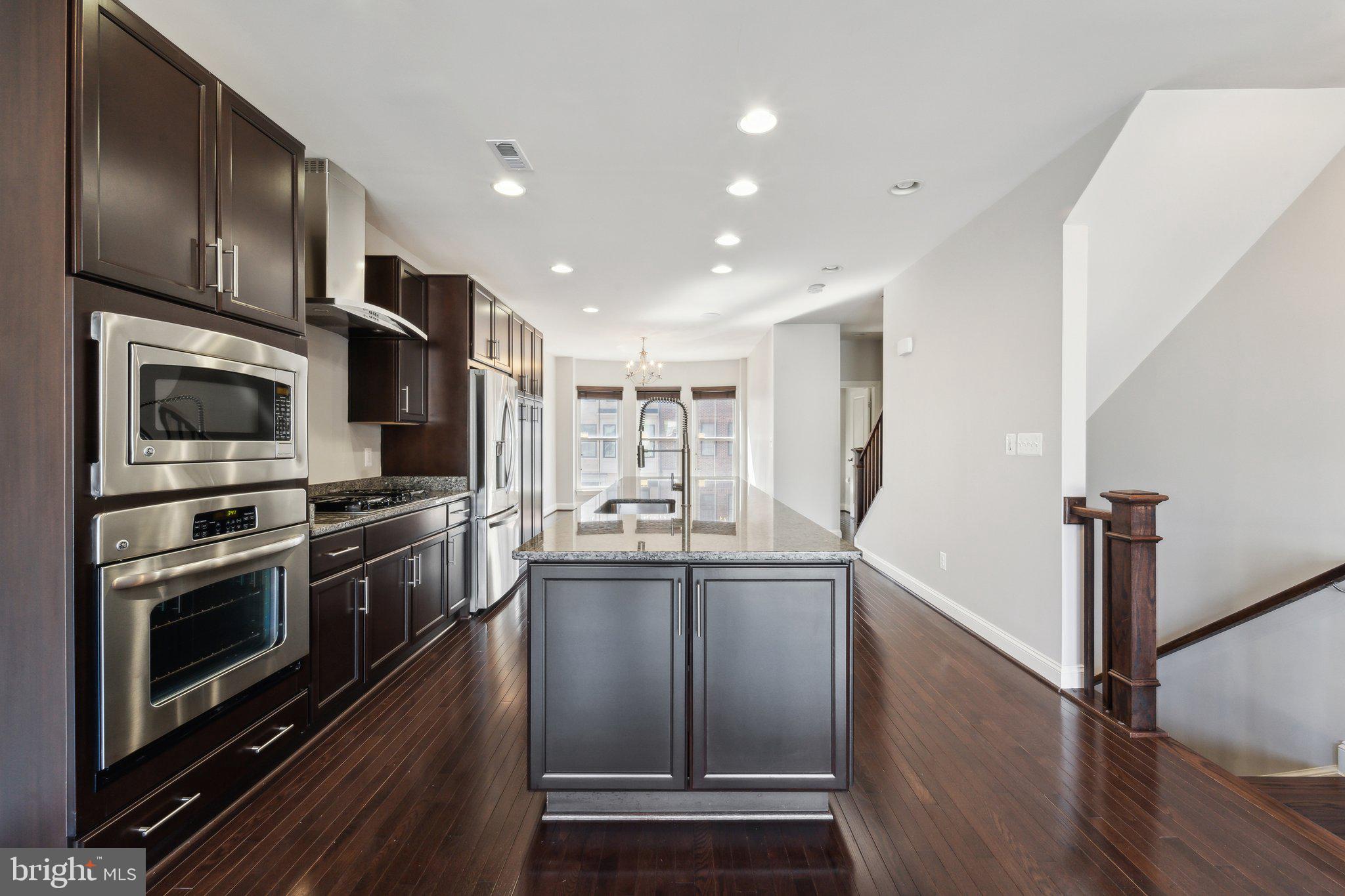 20398 Codman Drive Ashburn, VA 20147 - Photo 12 of 39 a kitchen with stainless steel appliances granite countertop a refrigerator and a stove top oven