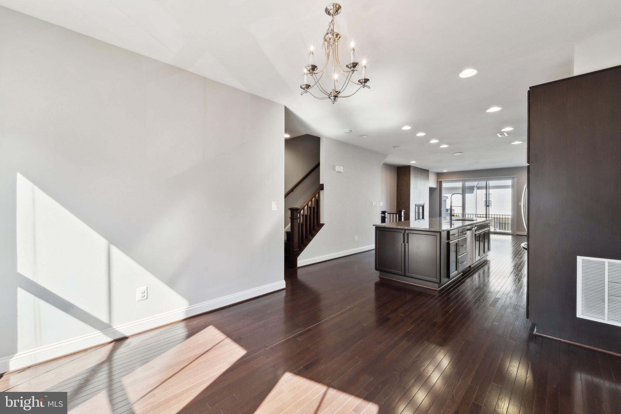 20398 Codman Drive Ashburn, VA 20147 - Photo 14 of 39 a view of a living room with wooden floor and a kitchen