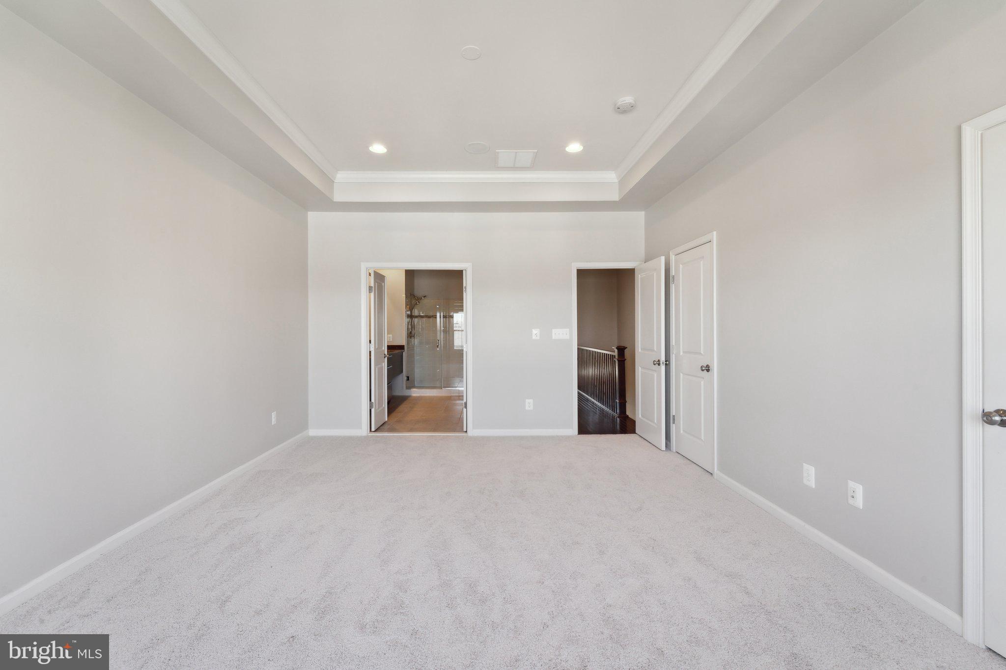 20398 Codman Drive Ashburn, VA 20147 - Photo 24 of 39 a view of an empty room with wooden floor and kitchen