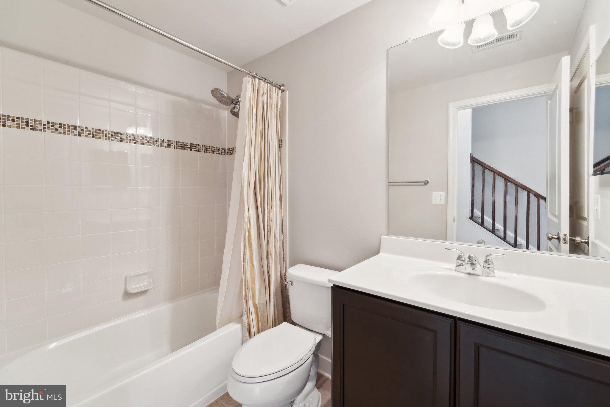 20398 Codman Drive Ashburn, VA 20147 - Photo 6 of 39 a bathroom with a sink a toilet and shower
