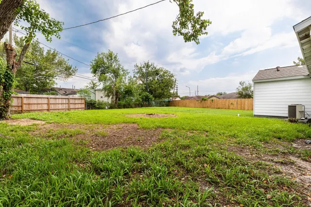 a view of yard with swimming pool and green space