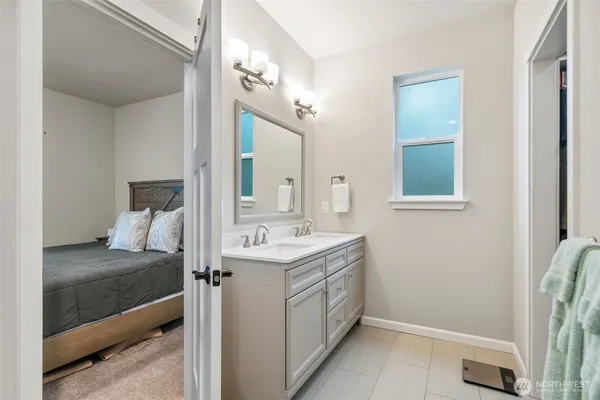 a bathroom with a sink vanity and a mirror