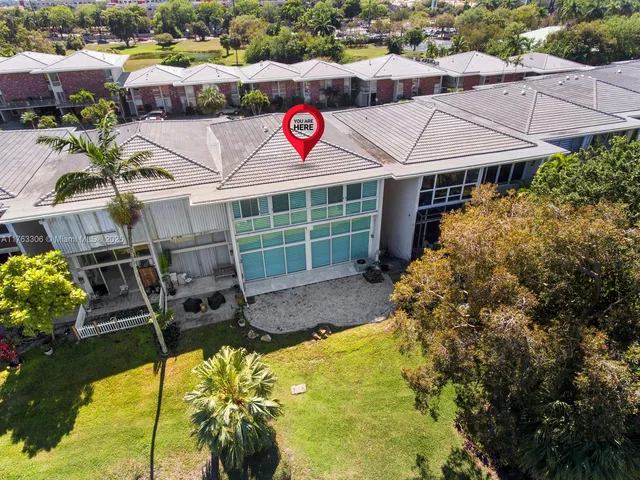 a view of a house with a swimming pool and a yard