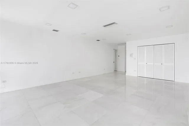 a vase of flowers sitting on a table in front of a building