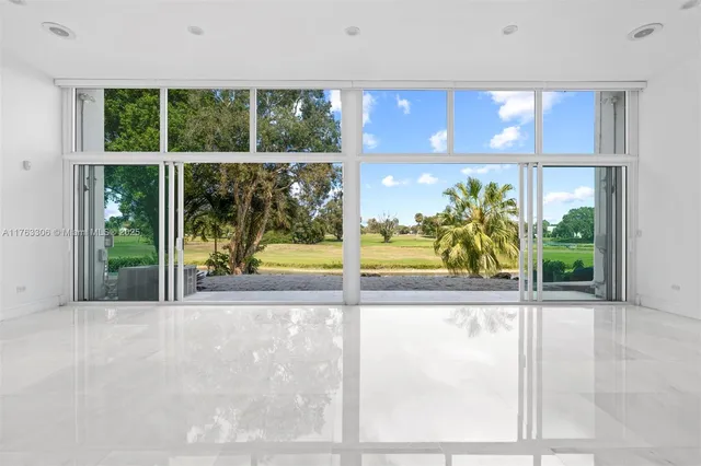 a view of open kitchen with a table and chairs and potted plants