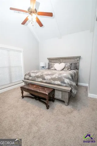 a bed sitting in a room next to a window