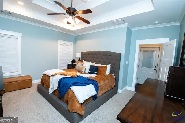 a bedroom with bed and a chandelier