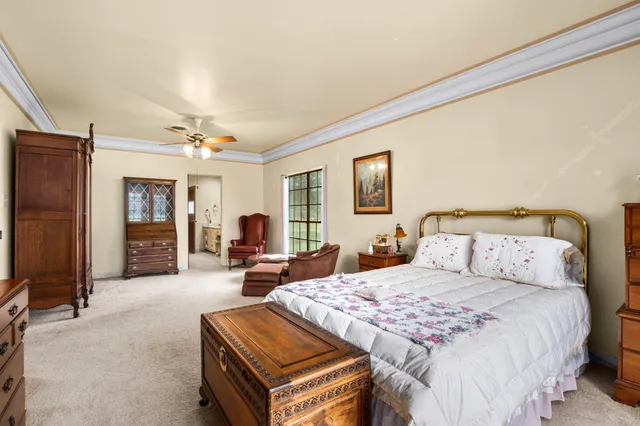 a bedroom with bed and a chandelier