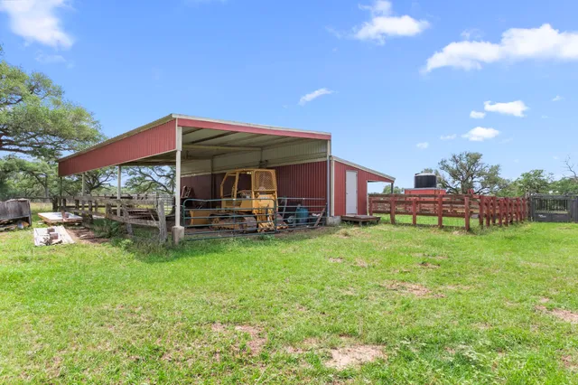 a view of a house with backyard porch and sitting area