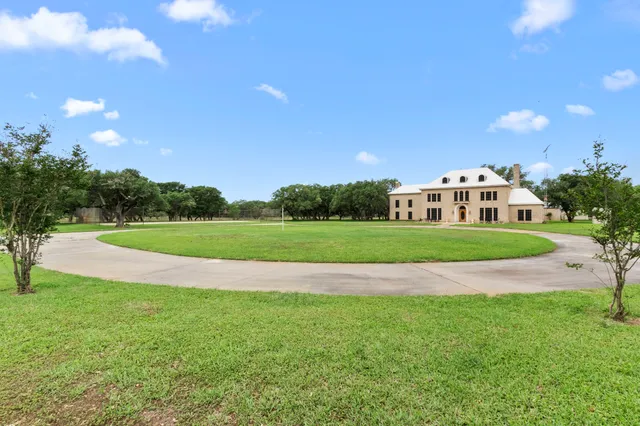 a view of a big house with a big yard