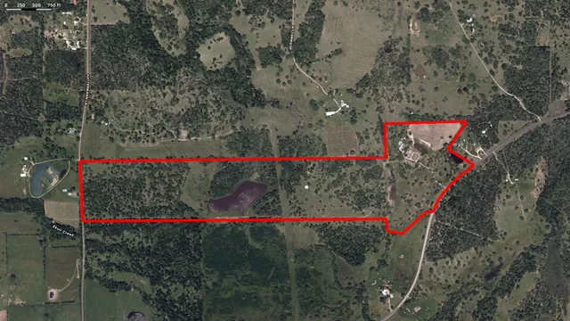 an aerial view of a house with swimming pool and outdoor space