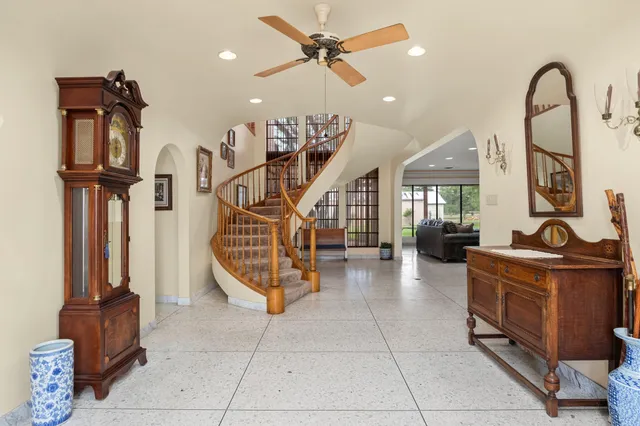 a living room with furniture a flat screen tv and a window