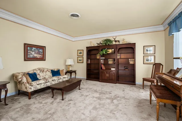 a living room with furniture and a bed