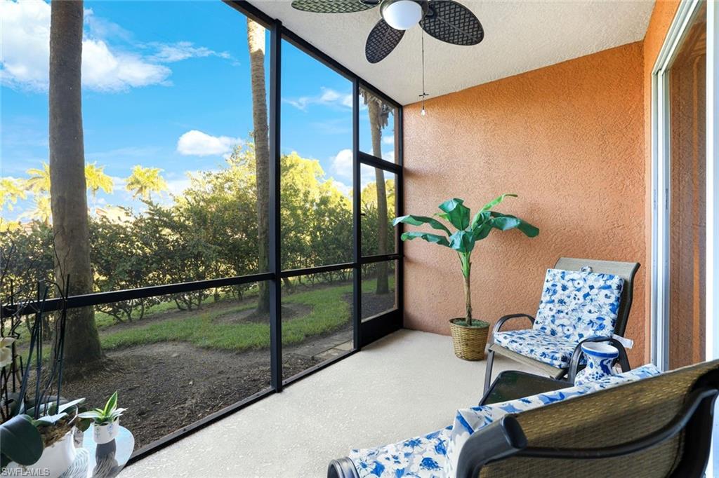 10049 Heather Lane, Unit 101 Naples, FL 34119 - Photo 26 of 28 Unfurnished sunroom featuring a ceiling fan and view of wooded area