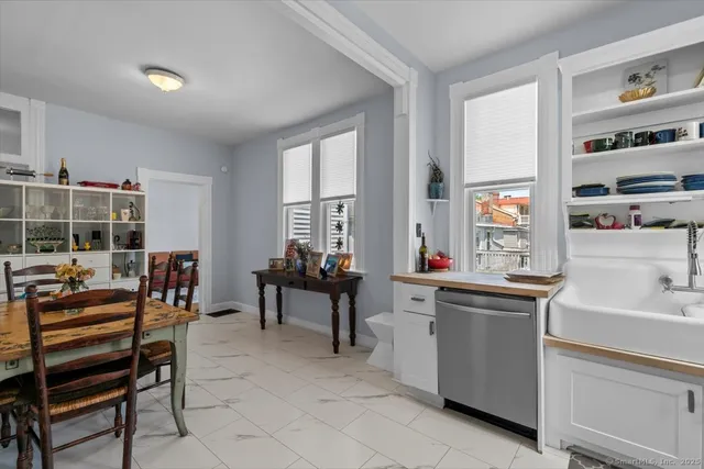 a living room with furniture a flat screen tv and a window