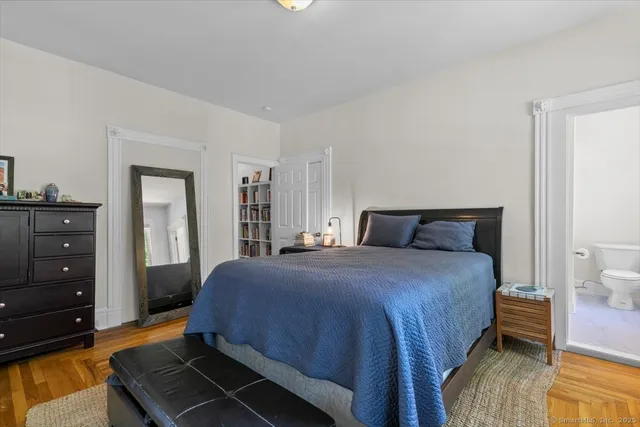 a bedroom with a bed and a dresser