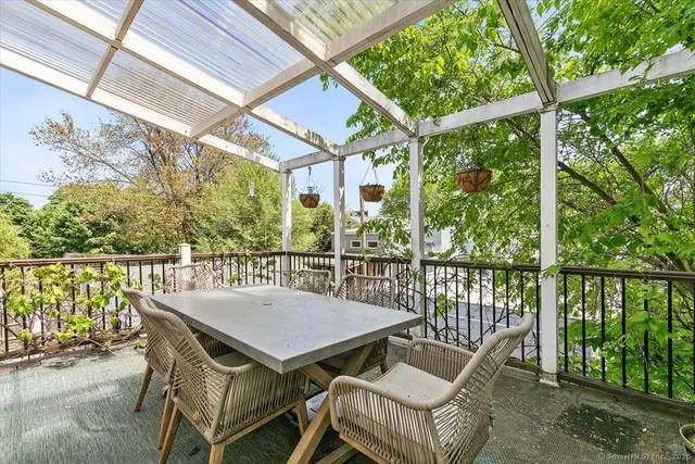 a view of a chairs and table in the balcony