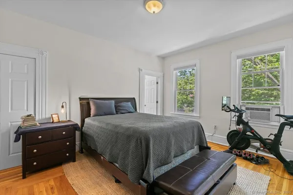 a bed room with a bed and windows