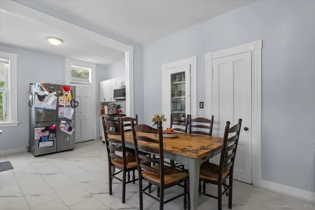 a view of a dining room with furniture and a window