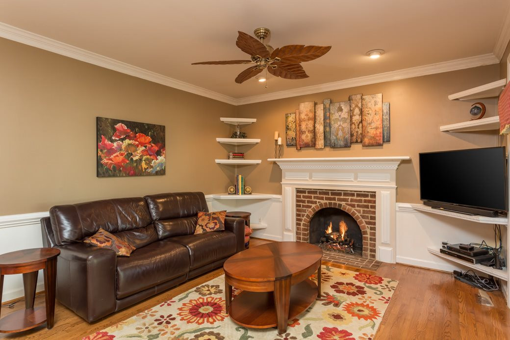 5215 Coffee Tree Drive Raleigh, NC 27613 - Photo 12 of 25 Entertaining is easy with such a large family room open to the kitchen. The brick fireplace keeps the room warm and cozy. Family Room