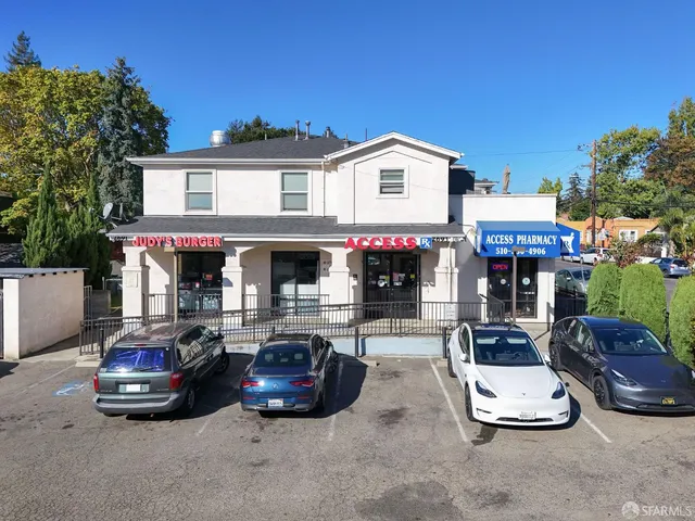 a view of a patio with table and chairs under an umbrella