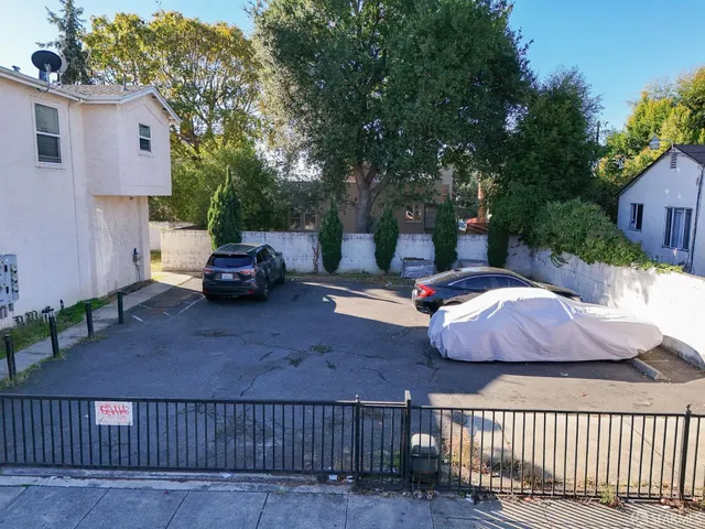 a view of a patio with table and chairs with wooden fence and plants