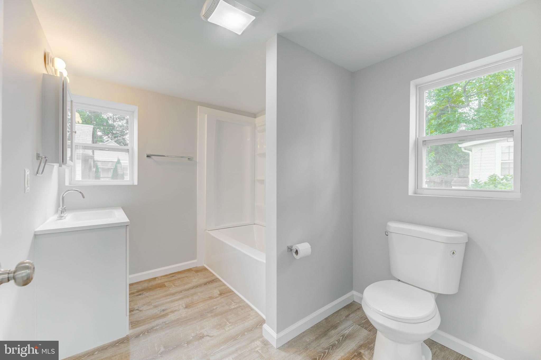 3911 3rd Street North Beach, MD 20714 - Photo 12 of 48 a bathroom with a toilet and a sink
