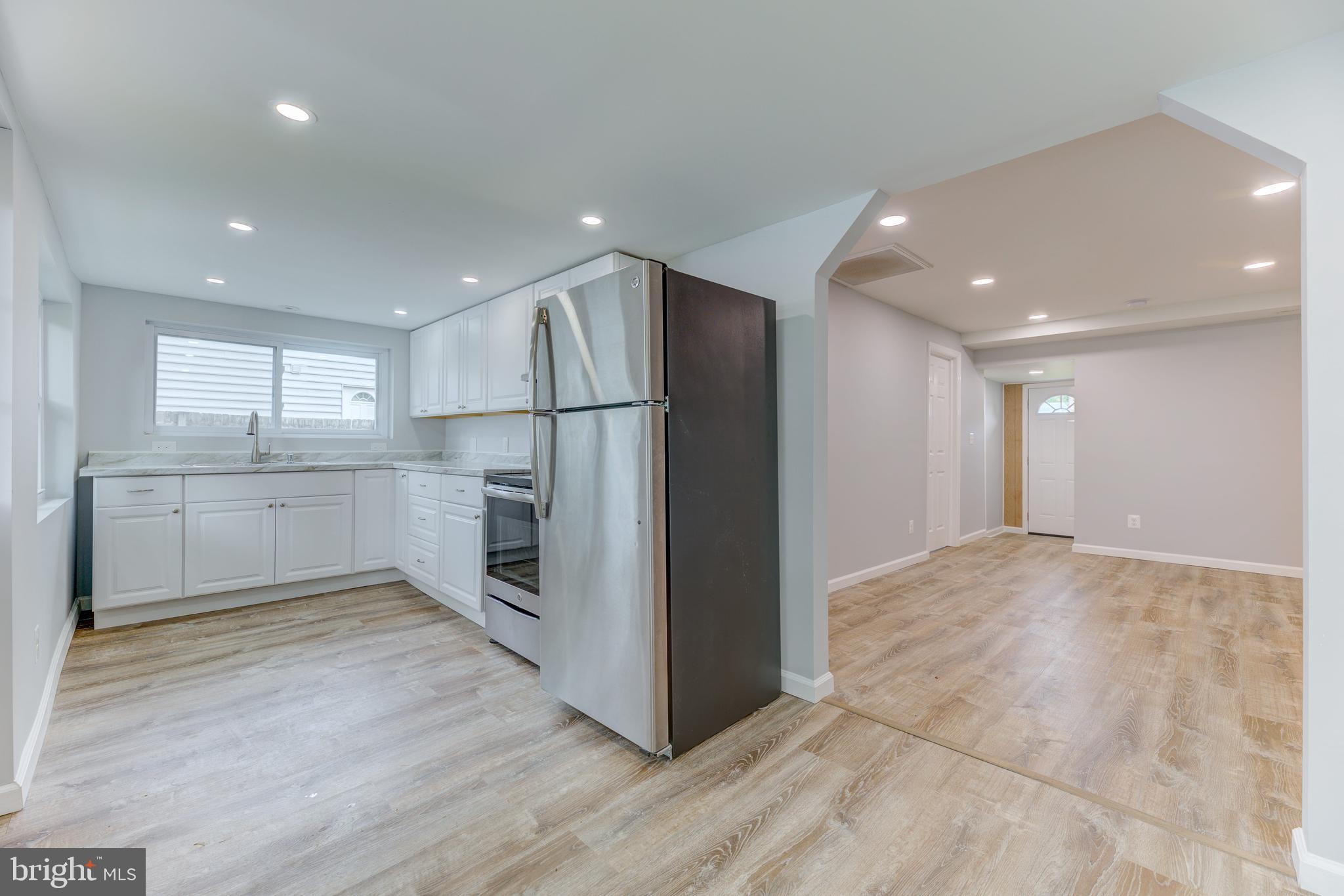 3911 3rd Street North Beach, MD 20714 - Photo 18 of 48 a view of a kitchen with a sink and a refrigerator
