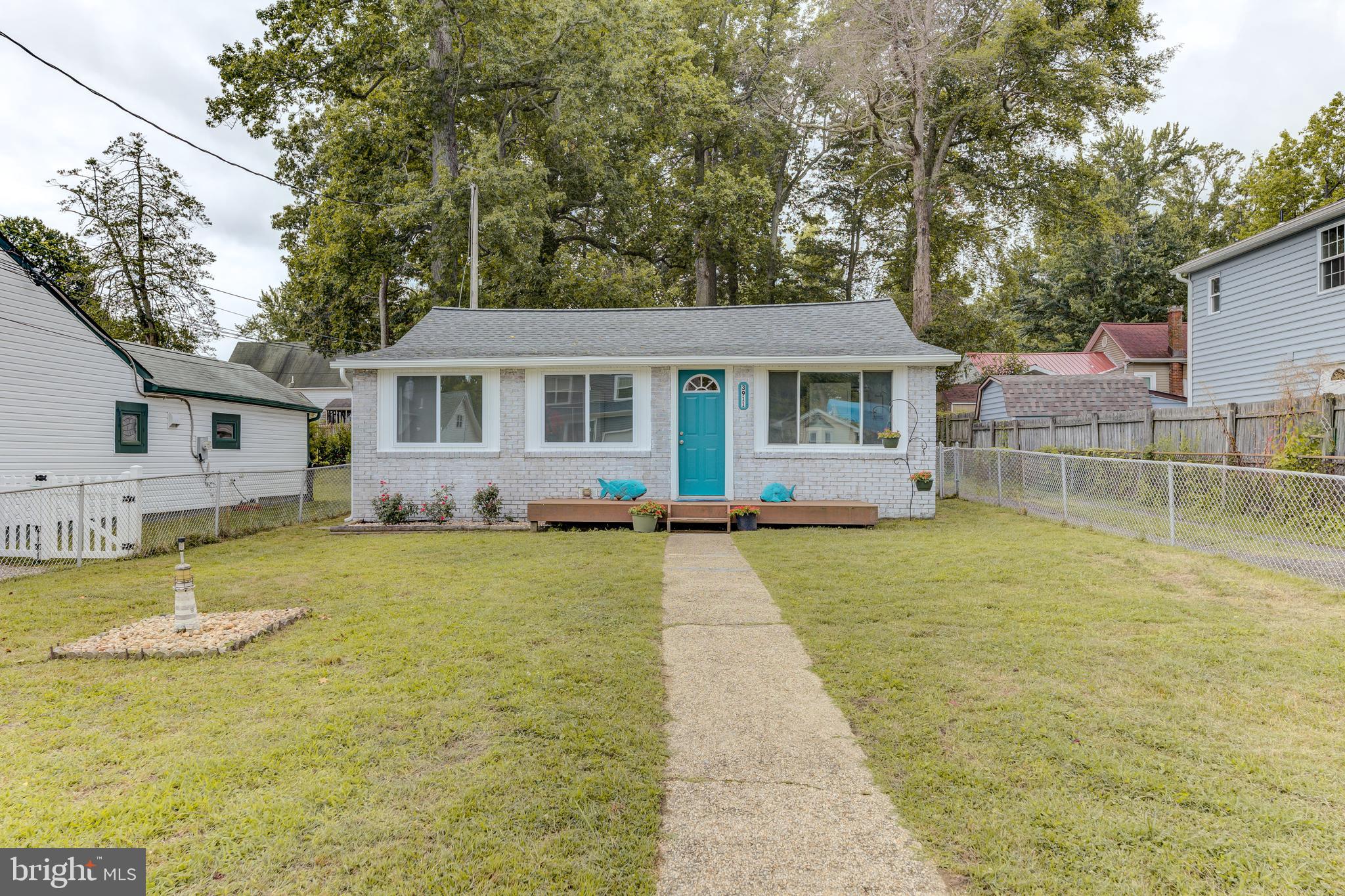 3911 3rd Street North Beach, MD 20714 - Photo 2 of 48 a view of a house with pool and chairs