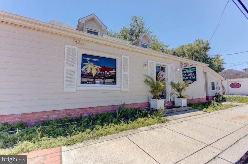 3911 3rd Street North Beach, MD 20714 - Photo 41 of 48 a front view of a house with a yard and a garage