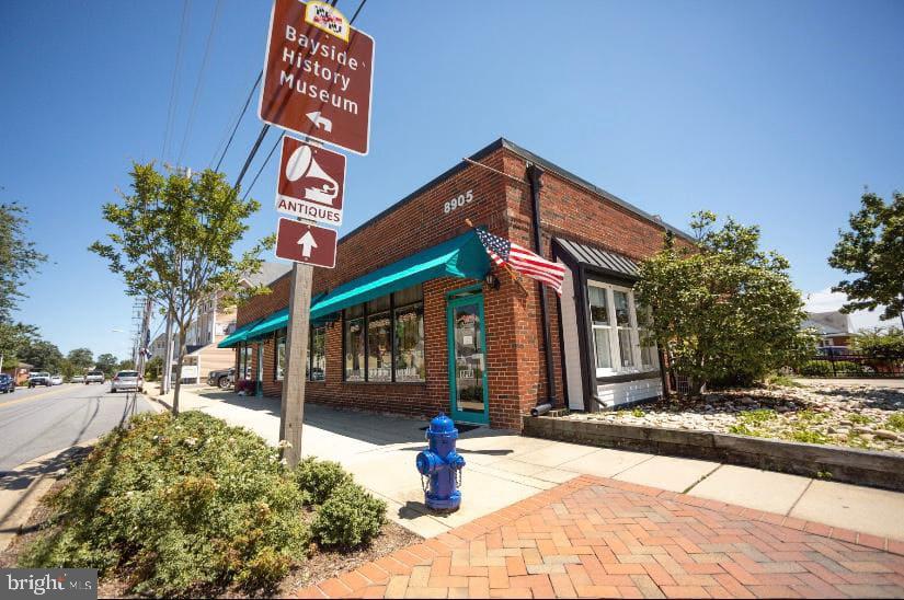 3911 3rd Street North Beach, MD 20714 - Photo 45 of 48 a street sign on a sidewalk next to a road