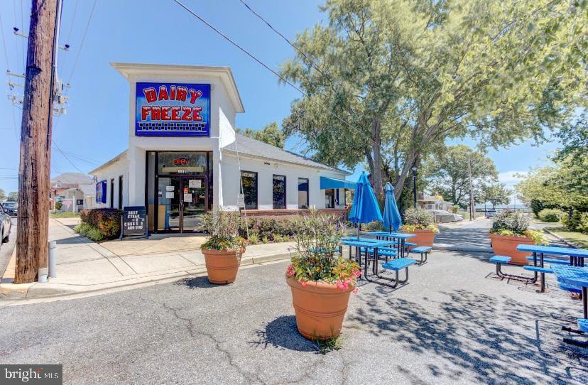 3911 3rd Street North Beach, MD 20714 - Photo 46 of 48 a view of a patio with dining table and chairs and a barbeque
