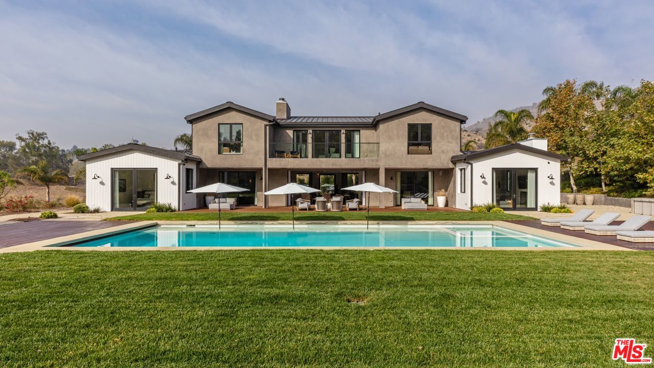 a front view of a house with a yard table and chairs