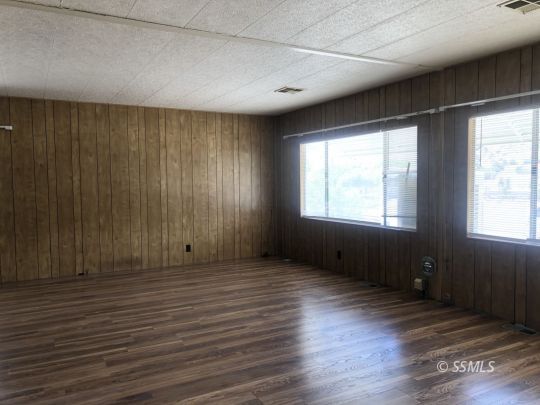 3713 Goat Ranch Road Mountain Mesa, CA 93240 - Photo 6 of 43 a view of an empty room with wooden floor and a window