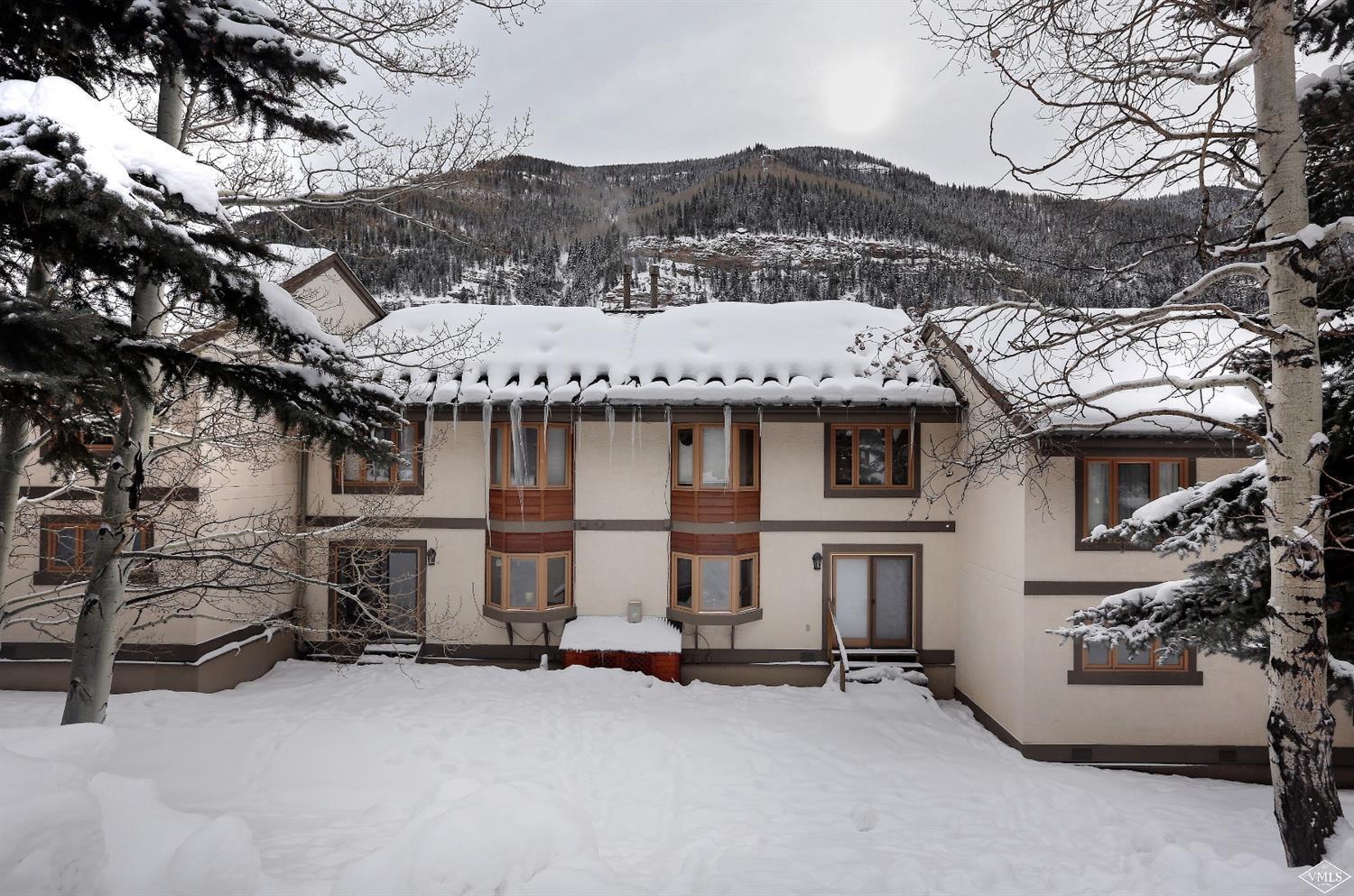 2335 Bald Mountain Road, Unit A5 Vail, CO 81657 - Photo 15 of 17 a view of a house with a patio and a fire pit