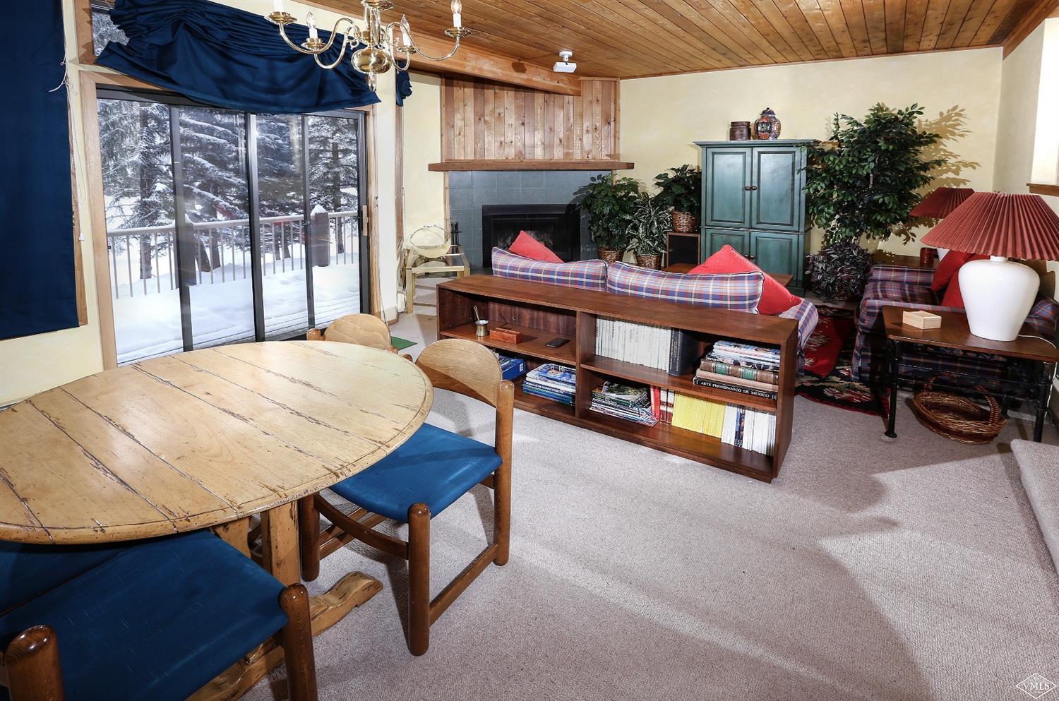 2335 Bald Mountain Road, Unit A5 Vail, CO 81657 - Photo 3 of 17 a bedroom with furniture and a fireplace