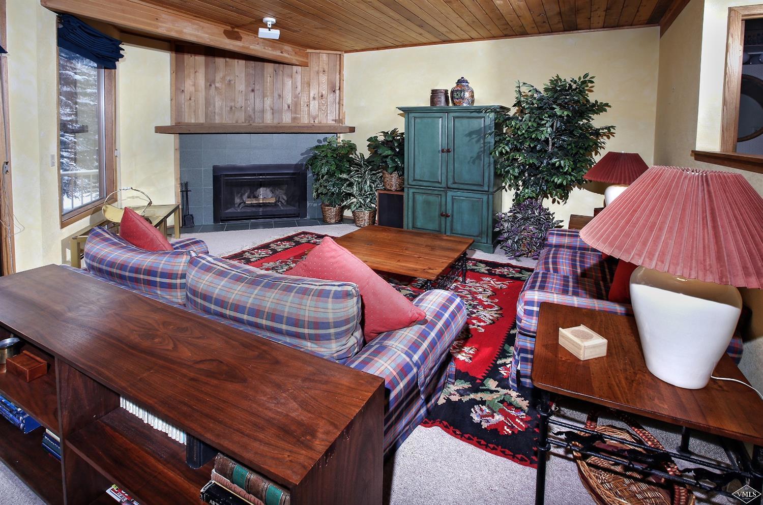 2335 Bald Mountain Road, Unit A5 Vail, CO 81657 - Photo 4 of 17 a living room with furniture and a fireplace