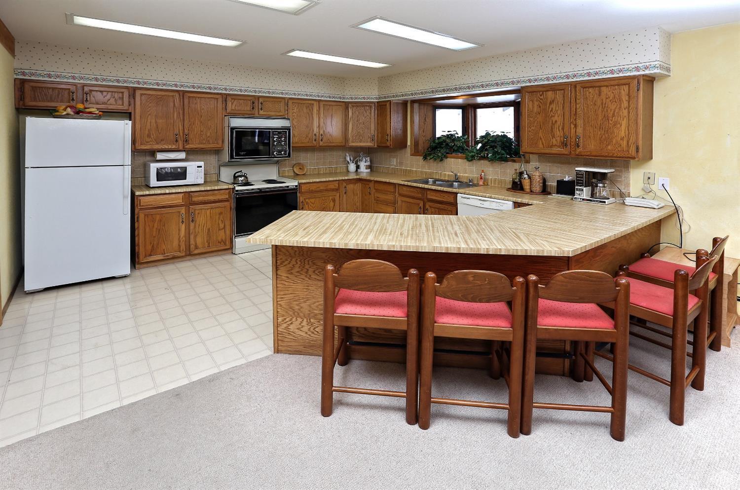 2335 Bald Mountain Road, Unit A5 Vail, CO 81657 - Photo 6 of 17 a kitchen with a table chairs microwave and refrigerator