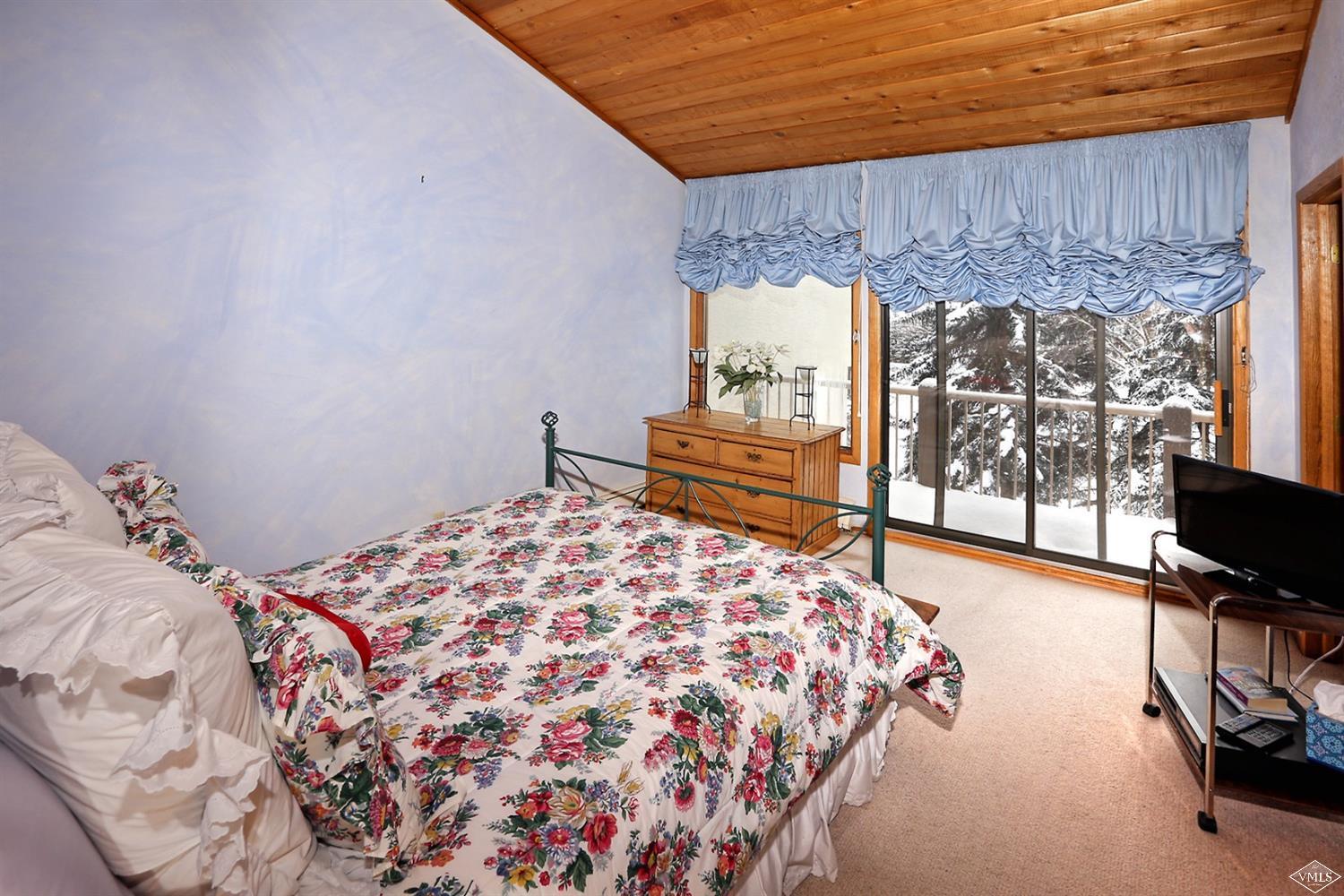 2335 Bald Mountain Road, Unit A5 Vail, CO 81657 - Photo 7 of 17 a bedroom with a bed and wooden floor