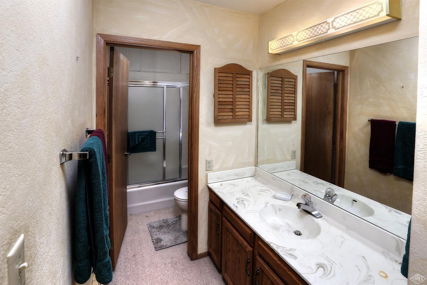 2335 Bald Mountain Road, Unit A5 Vail, CO 81657 - Photo 8 of 17 a bathroom with a granite countertop sink a large mirror and a shower