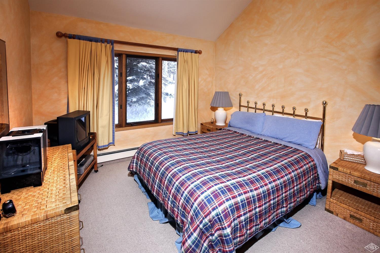 2335 Bald Mountain Road, Unit A5 Vail, CO 81657 - Photo 9 of 17 a bedroom with a bed and wooden floor