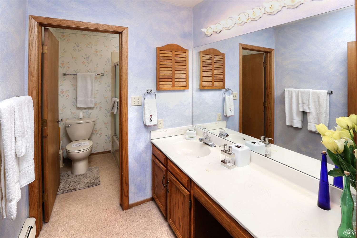 2335 Bald Mountain Road, Unit A5 Vail, CO 81657 - Photo 10 of 17 a spacious bathroom with a sink a toilet and a large mirror